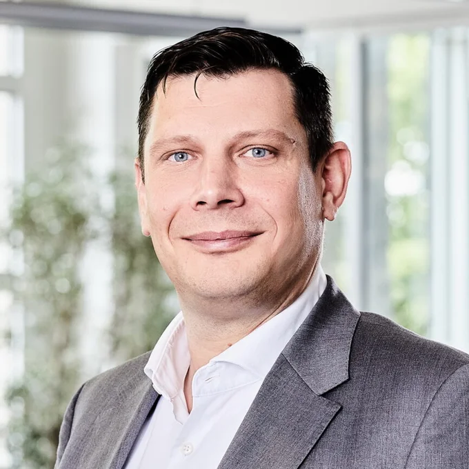 Ein Mann lächelt in die Kamera