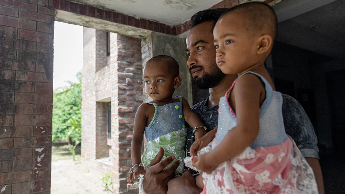 Uncle holding the twins.