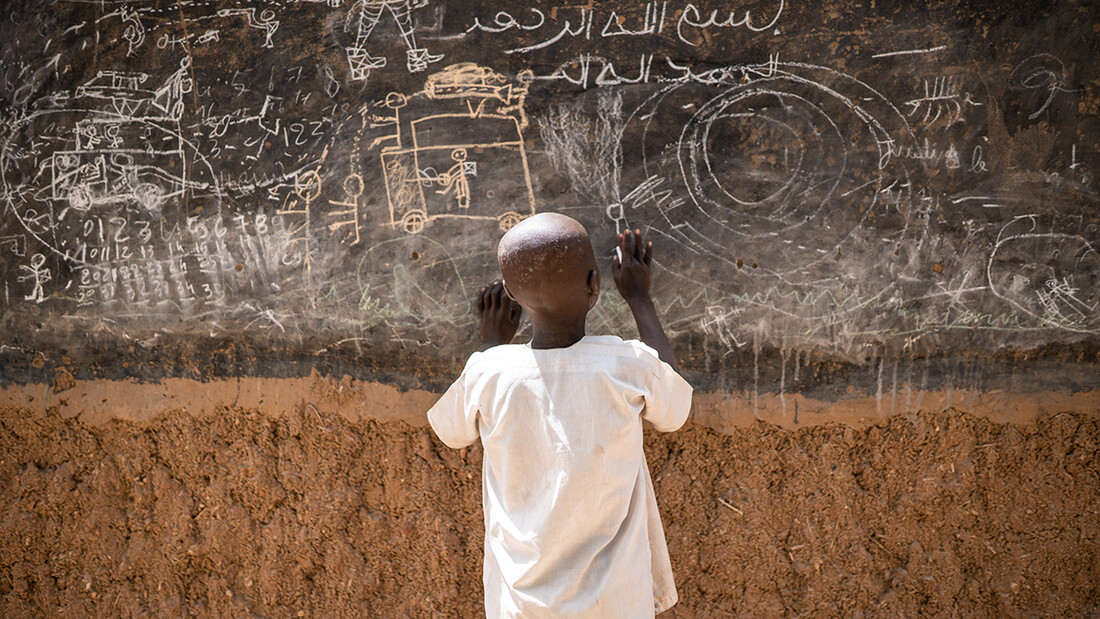 Boy on a blackboard.