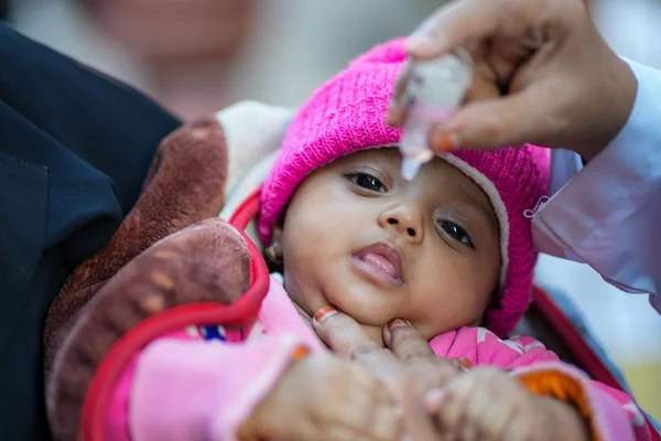 A baby receives a polio vaccination