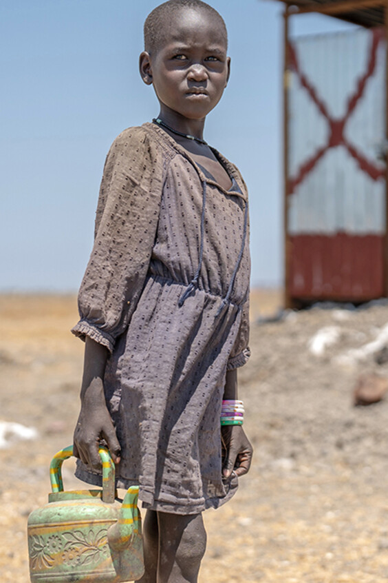Ein sudanesisches Mädchen ist auf der Suche nach Wasser.